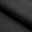 HARUKI SISAL Jet black textured sisal wallpaper by Schumacher, shown in a close-up and in a stack of colorways.