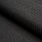 HARUKI SISAL Jet black textured sisal wallpaper by Schumacher, shown in a close-up and in a stack of colorways.