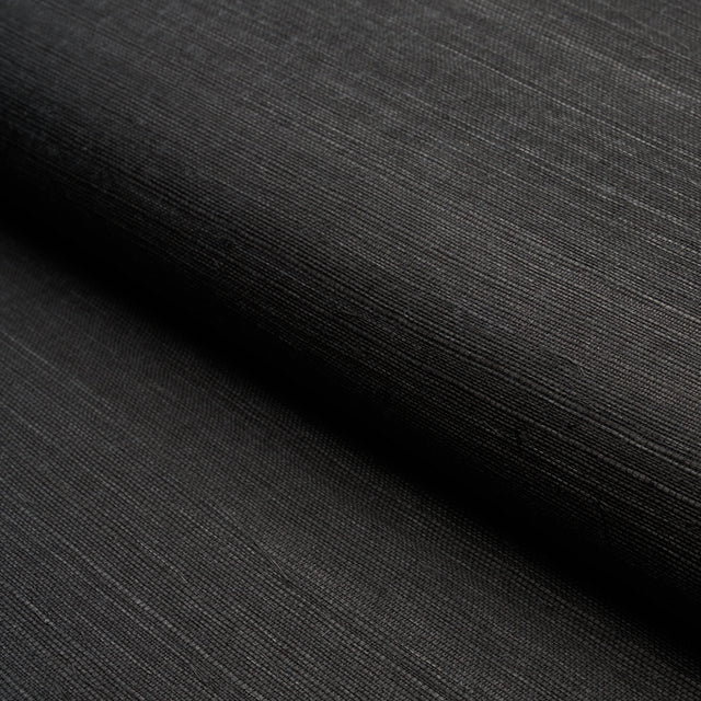 HARUKI SISAL Jet black textured sisal wallpaper by Schumacher, shown in a close-up and in a stack of colorways.