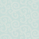 Leafy Scroll wallpaper in Sky by Schumacher, featuring a scrolling vine pattern inspired by embroidery, shown in a bathroom interior and close-up.