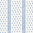 Katsura Stripe Delft wallpaper by Schumacher shown as a blue and white hand screen printed stripe and floral pattern in a bedroom interior.