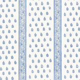 Katsura Stripe Delft wallpaper by Schumacher shown as a blue and white hand screen printed stripe and floral pattern in a bedroom interior.