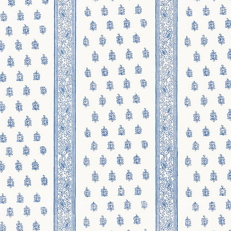 Katsura Stripe Delft wallpaper by Schumacher shown as a blue and white hand screen printed stripe and floral pattern in a bedroom interior.