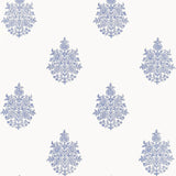 Asara Flower Delft blue and white floral medallion wallpaper by Schumacher, shown in a styled bedroom and close-up pattern view.