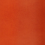 Shagreen Chinese Orange faux embossed wallpaper by Schumacher, pebbled texture, shown in orange and other colorways.