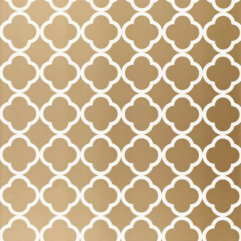 Moroccan-inspired antique gold geometric wallpaper with a quatrefoil pattern by Schumacher.