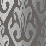 TOKAT wallpaper in graphite, a bold ikat-inspired pattern from Schumacher's Byzantium collection, shown in metallic silver and dark gray.