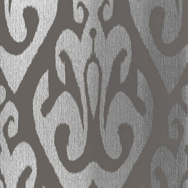 TOKAT wallpaper in graphite, a bold ikat-inspired pattern from Schumacher's Byzantium collection, shown in metallic silver and dark gray.