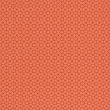 Medina Persimmon geometric wallpaper by Schumacher, intricate small-scale pattern in orange-red tones
