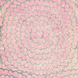 Feather Bloom Sisal wallpaper in Fuchsia & Jet by Celerie Kemble for Schumacher, featuring overscale blossoms in a radiating pattern on a natural sisal ground.