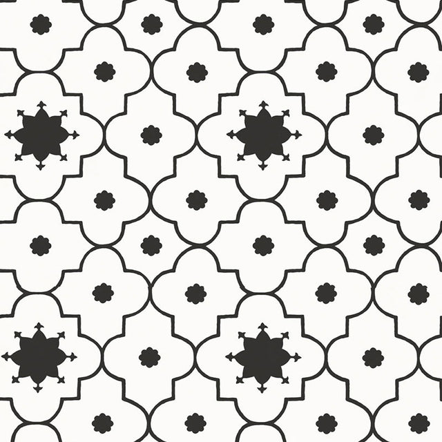 Taj Trellis Noir wallpaper by Schumacher shown in a modern interior with bold black and white geometric trellis pattern.