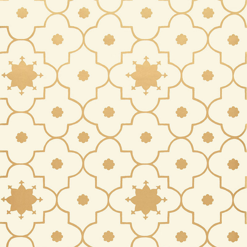 Taj Trellis wallpaper in Burnished Gilt by Schumacher, featuring a Moroccan-inspired geometric trellis pattern in gold on a cream background.