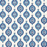 Samovar Peacock wallpaper by Schumacher, featuring a blue and white medallion pattern in a bathroom setting.