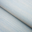 Haiku Sisal Cerulean wallpaper by Schumacher shown in a close-up and installed in a dining room setting.