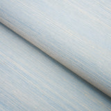 Haiku Sisal Cerulean wallpaper by Schumacher shown in a close-up and installed in a dining room setting.
