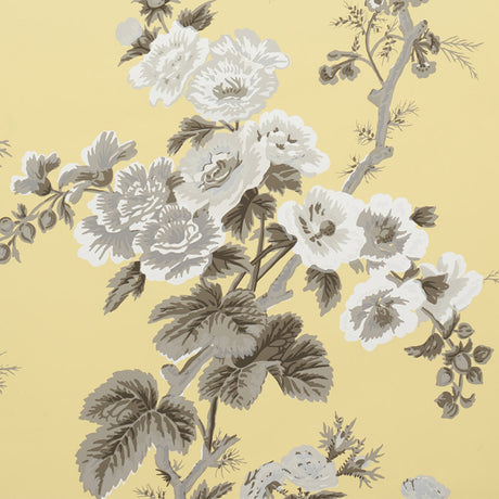 PYNE HOLLYHOCK Buttercup floral wallpaper by Schumacher, featuring hand-screened chintz pattern with white and grey hollyhock flowers on a yellow background.