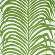 Zebra Palm Jungle wallpaper by Schumacher featuring bold green palm fronds on a white background, shown in various interior settings.