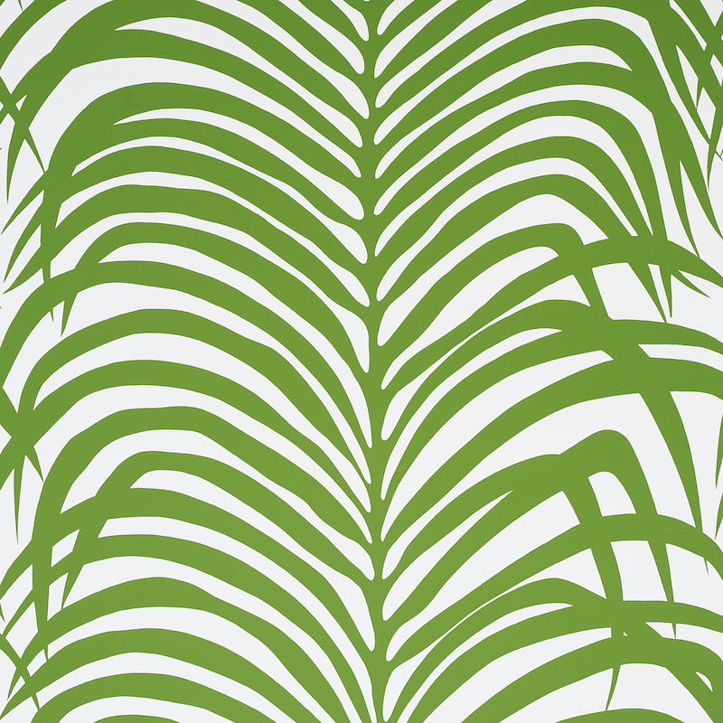 Zebra Palm Jungle wallpaper by Schumacher featuring bold green palm fronds on a white background, shown in various interior settings.