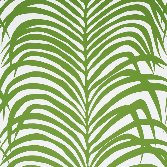 Zebra Palm Jungle wallpaper by Schumacher featuring bold green palm fronds on a white background, shown in various interior settings.