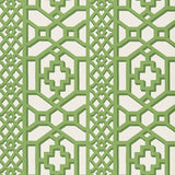 Zanzibar Trellis Jade geometric trellis wallpaper by Schumacher shown in a modern entryway with white paneling and green accents.