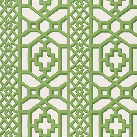 Zanzibar Trellis Jade geometric trellis wallpaper by Schumacher shown in a modern entryway with white paneling and green accents.
