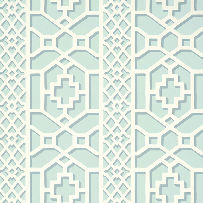 Zanzibar Trellis Winter Mint wallpaper by Schumacher in a geometric trellis pattern, shown in a styled interior setting.