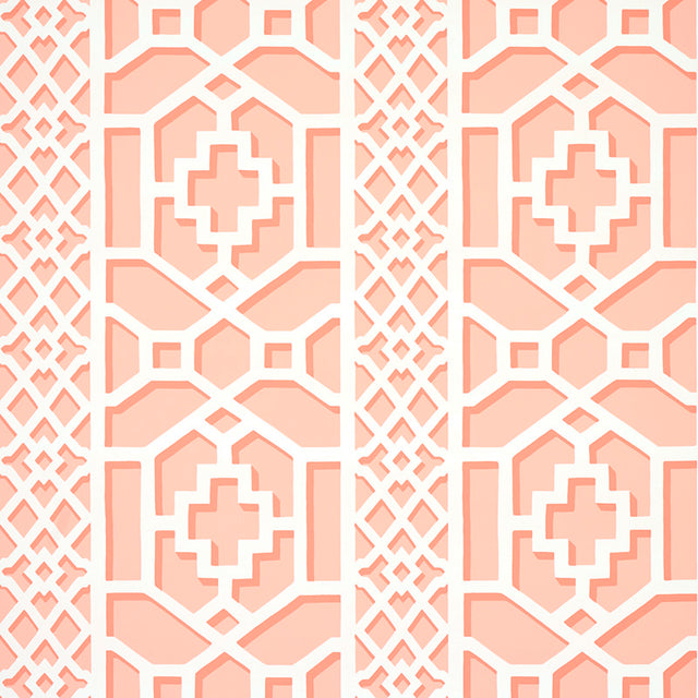 Zanzibar Trellis wallpaper in coral by Schumacher, featuring a bold geometric fretwork pattern inspired by Elsie de Wolfe's trellised rooms.