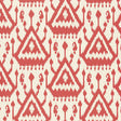Vientiane Ikat wallpaper in coral by Schumacher, featuring a bold geometric ikat pattern.