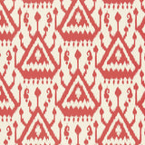 Vientiane Ikat wallpaper in coral by Schumacher, featuring a bold geometric ikat pattern.