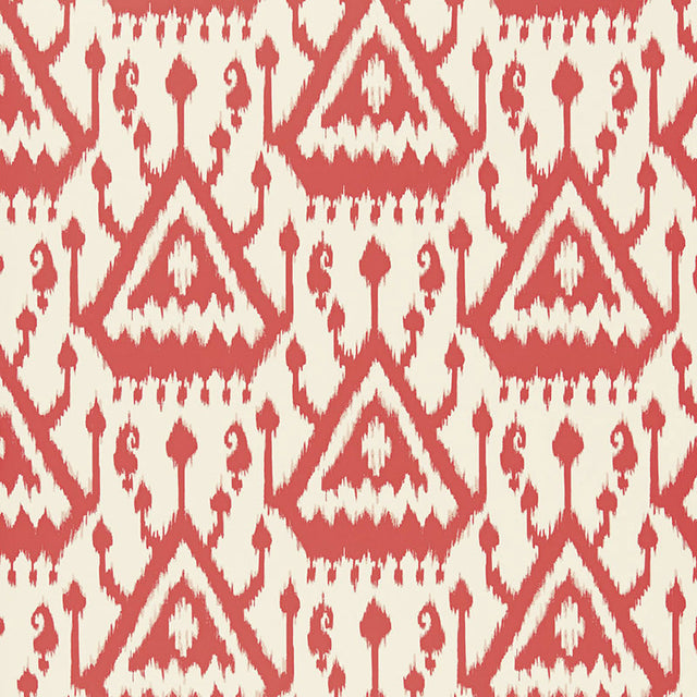 Vientiane Ikat wallpaper in coral by Schumacher, featuring a bold geometric ikat pattern.