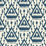 Vientiane Ikat Indigo wallpaper by Schumacher featuring a bold geometric ikat pattern in blue and white.