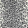 Iconic Leopard wallpaper in graphite by Schumacher, featuring a bold black and white animal print pattern on walls in various interior settings.
