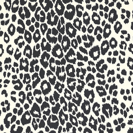 Iconic Leopard wallpaper in graphite by Schumacher, featuring a bold black and white animal print pattern on walls in various interior settings.