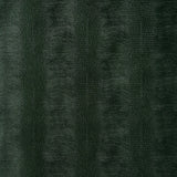 Komodo Forest Green embossed faux lizard wallpaper by Schumacher, shown in close-up and installed in a bathroom setting.