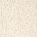 Faux Bois Sand Shimmer wallpaper by Schumacher shown in a stylized wood-grain pattern with a hint of iridescence, installed in a modern dining room.