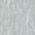 Drizzle Dove wallpaper by Schumacher, a subtle dotted pattern in soft grey and white, shown in detail and installed in a modern interior.