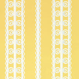 Wicker Stripe wallpaper in Lemon Blossom by Schumacher, featuring a yellow background with white wicker-inspired vertical stripes. Shown in a styled bedroom interior.