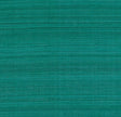 Shaded Silk Peacock wallcovering by Schumacher in a teal blue-green silk texture, shown in a styled interior with a velvet chair.