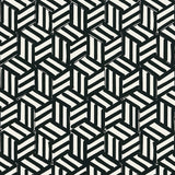 TUMBLING BLOCKS black and white geometric wallpaper by Schumacher, shown in a bathroom interior and as a pattern close-up.