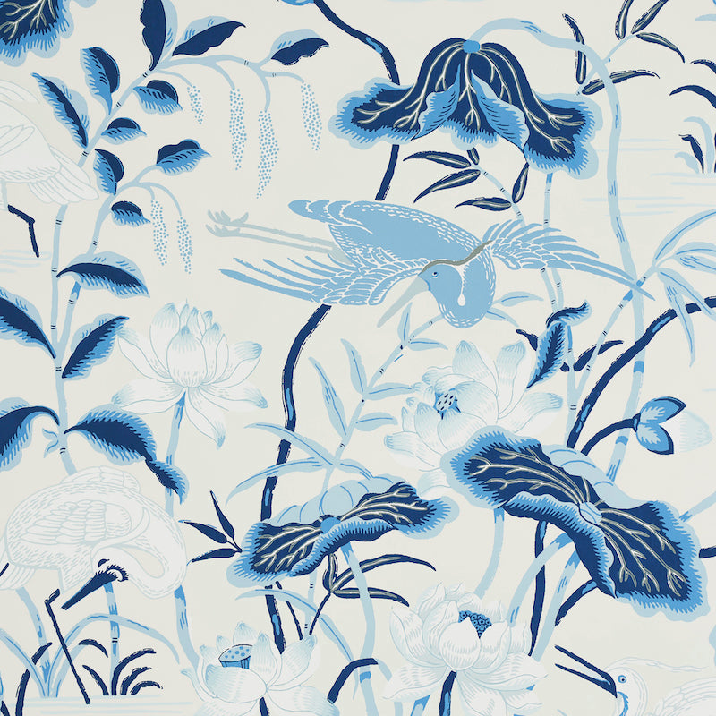 Lotus Garden Porcelain wallpaper by Schumacher featuring blue and white Japanese-inspired floral and bird motifs.