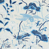 Lotus Garden Porcelain wallpaper by Schumacher featuring blue and white Japanese-inspired floral and bird motifs.