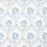 Marella Delft wallpaper by Schumacher featuring a wavy trellis and blue botanical motifs in a traditional interior setting.