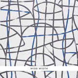 Abstratto Black & Cobalt abstract geometric wide-width wallpaper by Schumacher, shown in a modern bedroom setting.