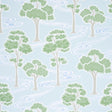 Tree River wallpaper in Mineral by Schumacher, featuring stylized green trees and flowing blue river on a light background, shown in a bedroom setting.