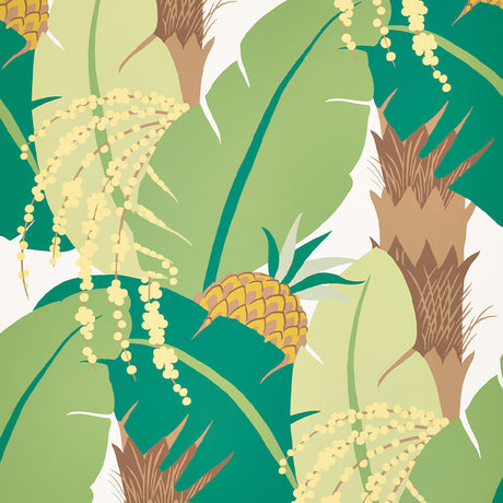Tropical pineapple and banana leaf wallpaper in green, yellow, and brown, Ananas by Schumacher, shown in a kitchen setting.