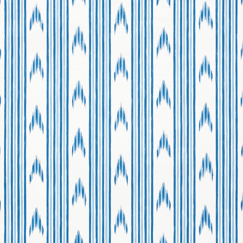 Santa Barbara Ikat Indigo wallpaper by Schumacher, featuring a blue and white ikat stripe pattern in a modern interior setting.