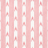 Santa Barbara Ikat pink wallpaper by Schumacher in a bathroom setting, featuring a vertical ikat stripe pattern.