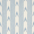Santa Barbara Ikat wallpaper in China Blue by Schumacher, featuring a blue and white ikat stripe pattern, styled in a kitchen interior.