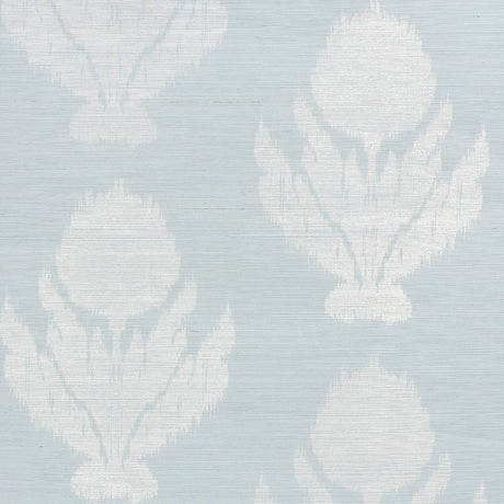 Agra Sisal wallpaper in Sky by Schumacher, featuring a soft-edged floral ikat pattern on a natural sisal ground, shown in a bathroom interior.