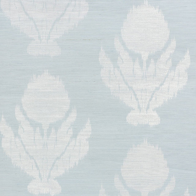 Agra Sisal wallpaper in Sky by Schumacher, featuring a soft-edged floral ikat pattern on a natural sisal ground, shown in a bathroom interior.
